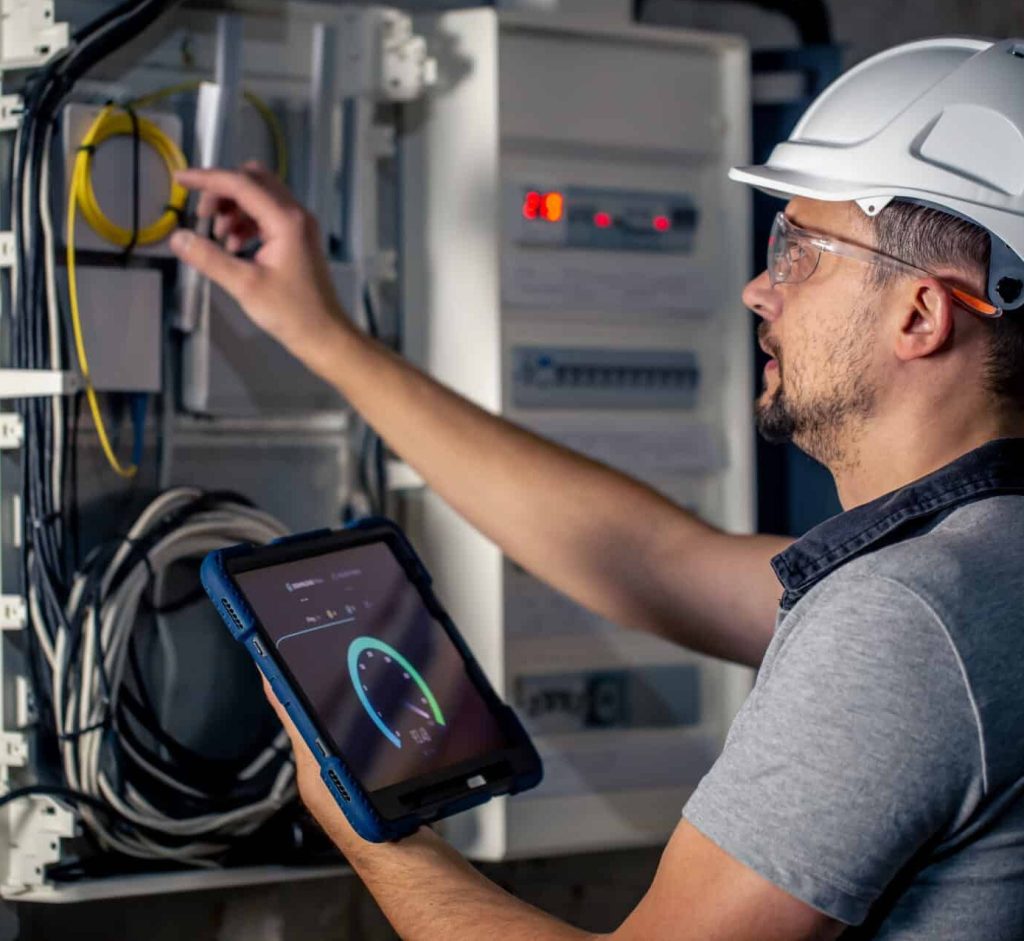 Technician working in a switchboard